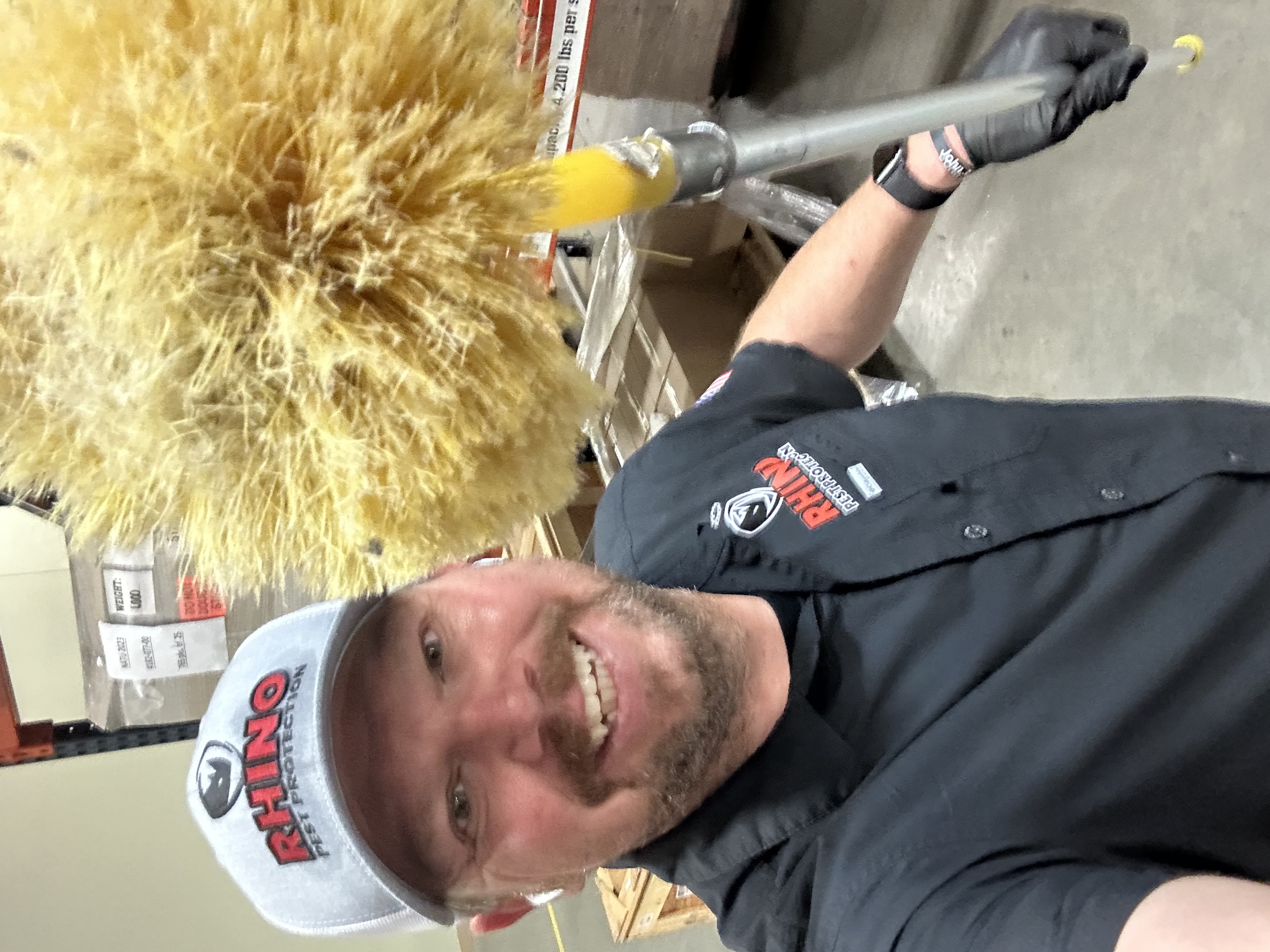 Gary Kirkowski, owner of Rhino Pest Protection, holding a yellow duster
