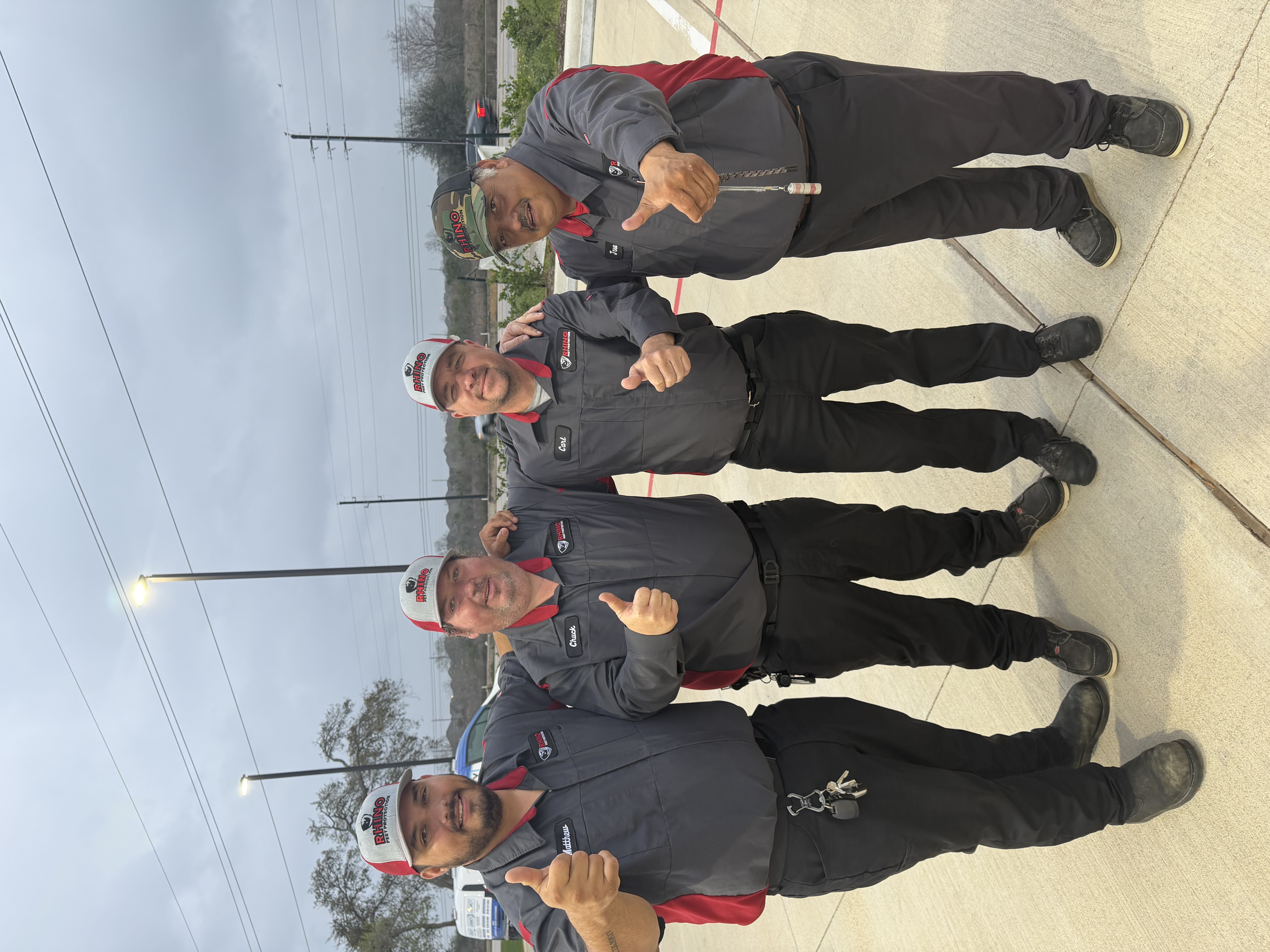 The Rhino Pest Protection crew of four technicians in branded uniforms