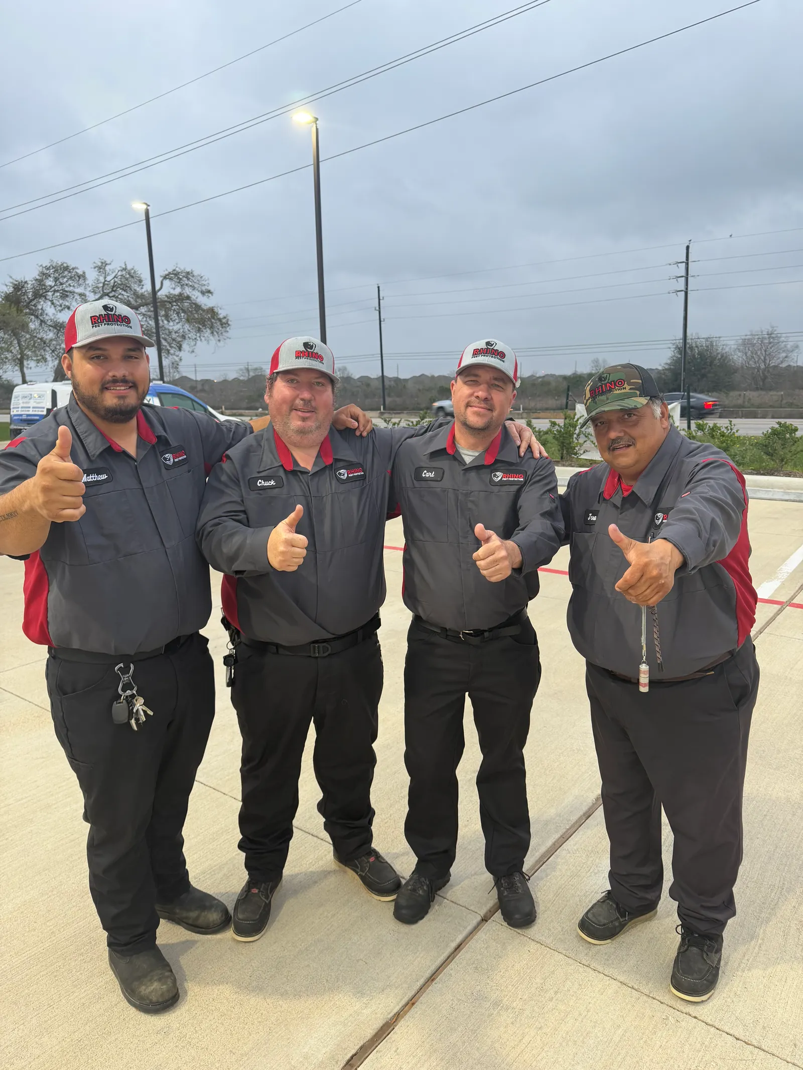 The Rhino Pest Protection crew of four technicians in branded uniforms